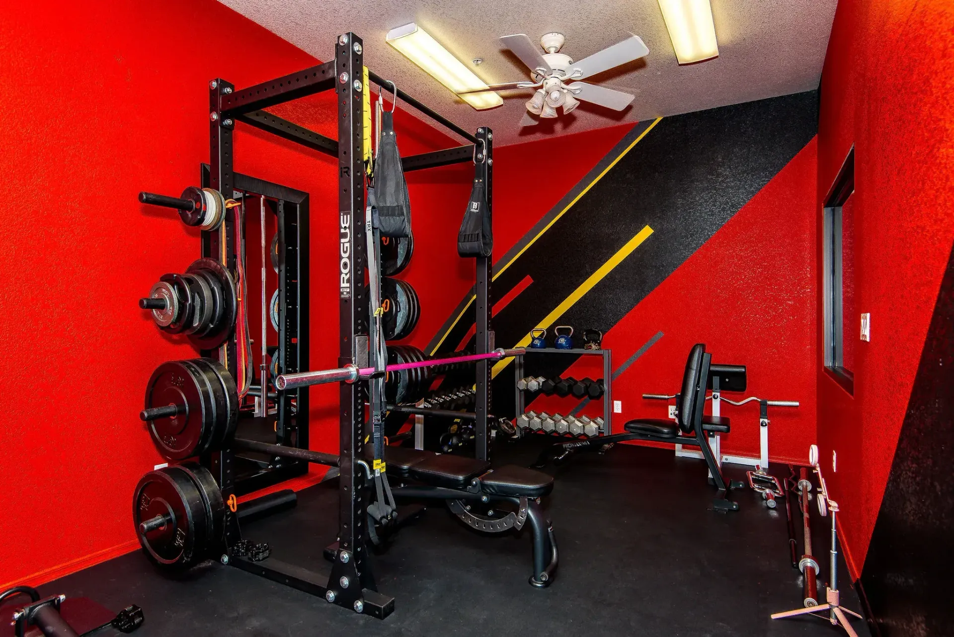 Form and Function Fitness gym in Fort Mohave, AZ with power rack, weight plates, bench, and black floor mats
