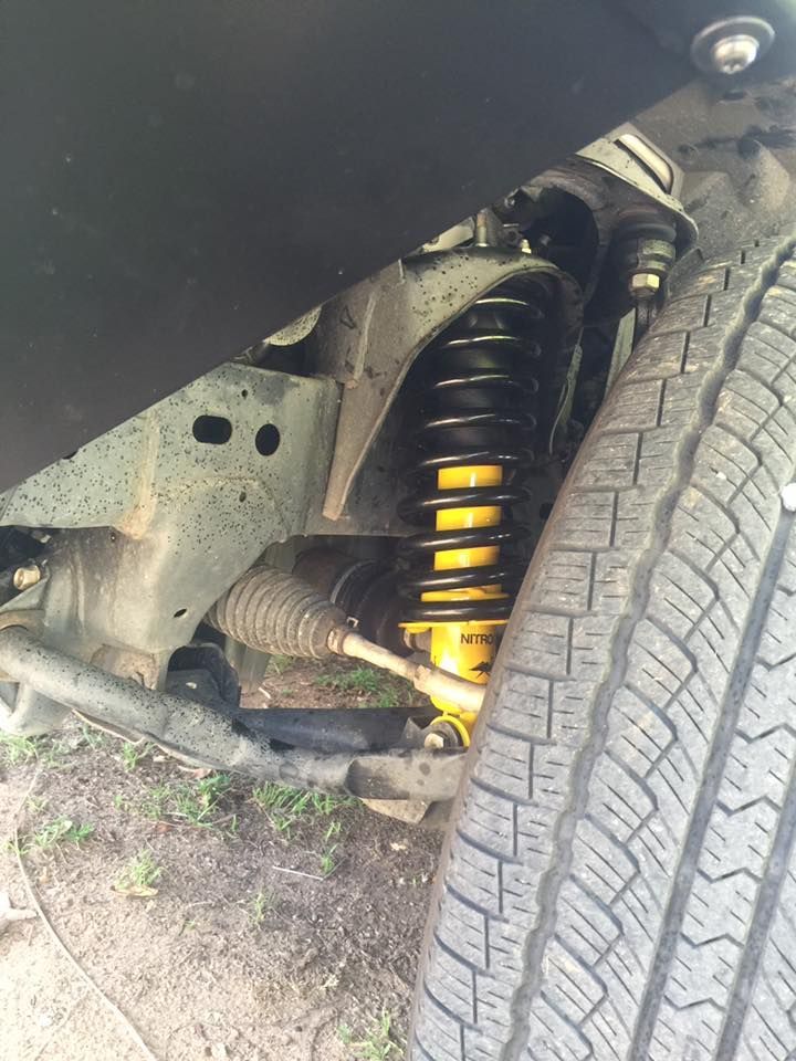 A Close Up of the Underside of a Car With a Shock Absorber and a Tyre — Emerald 4x4 in Emerald, QLD