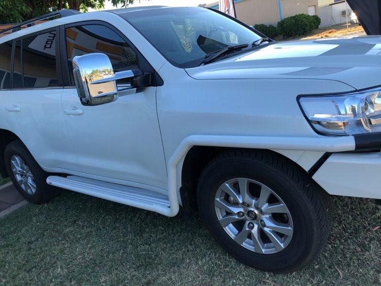 A White Suv is Parked on the Grass in Front of a Building — Emerald 4x4 in Emerald, QLD