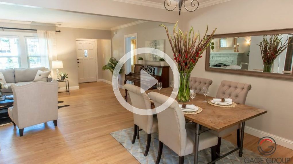 A living room with a dining room table and chairs.