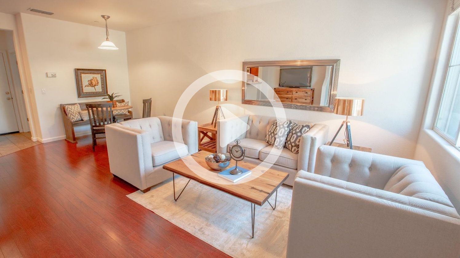 A living room with a couch , chairs , and a coffee table.