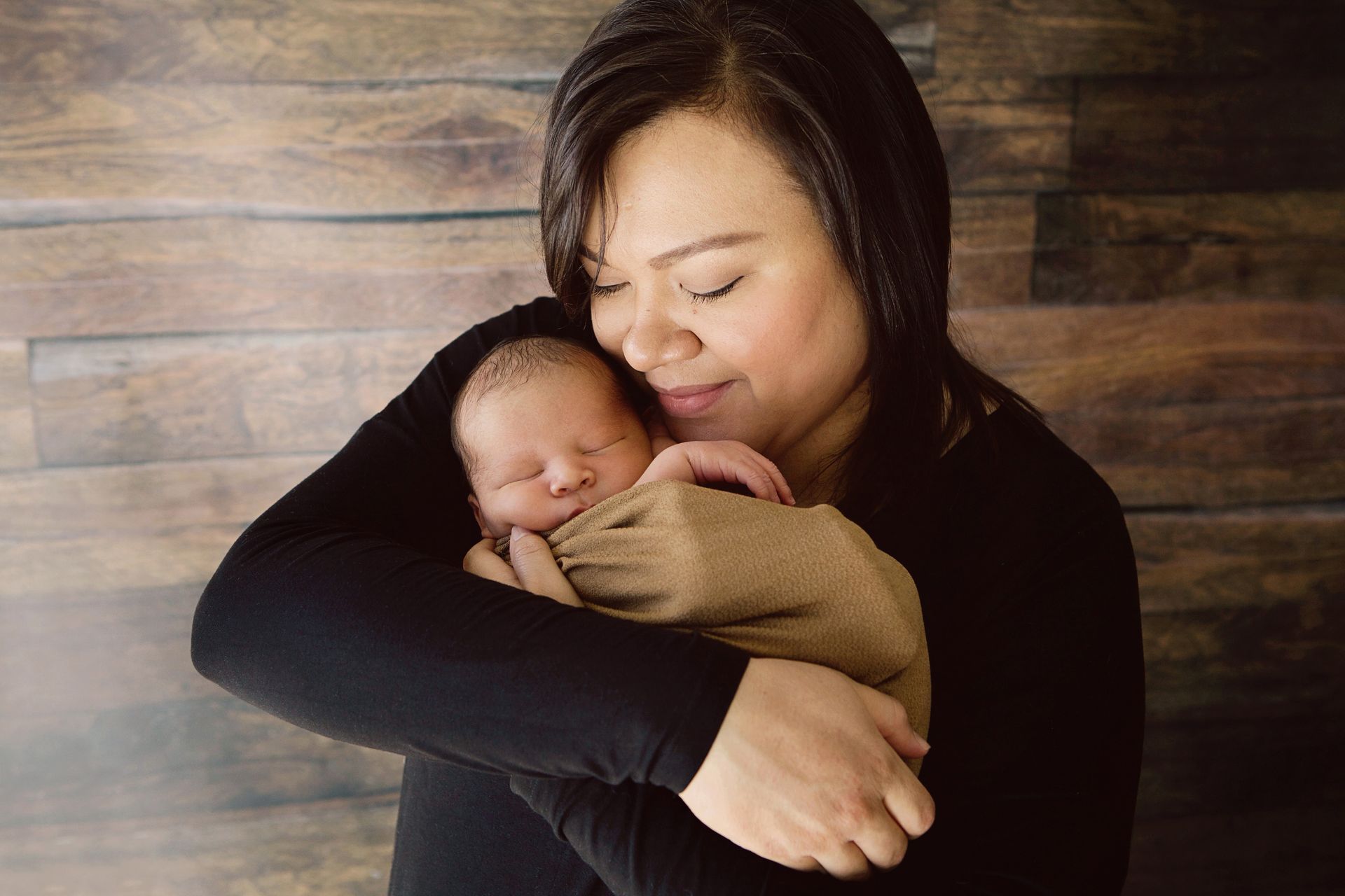 Mother snuggling her newborn baby