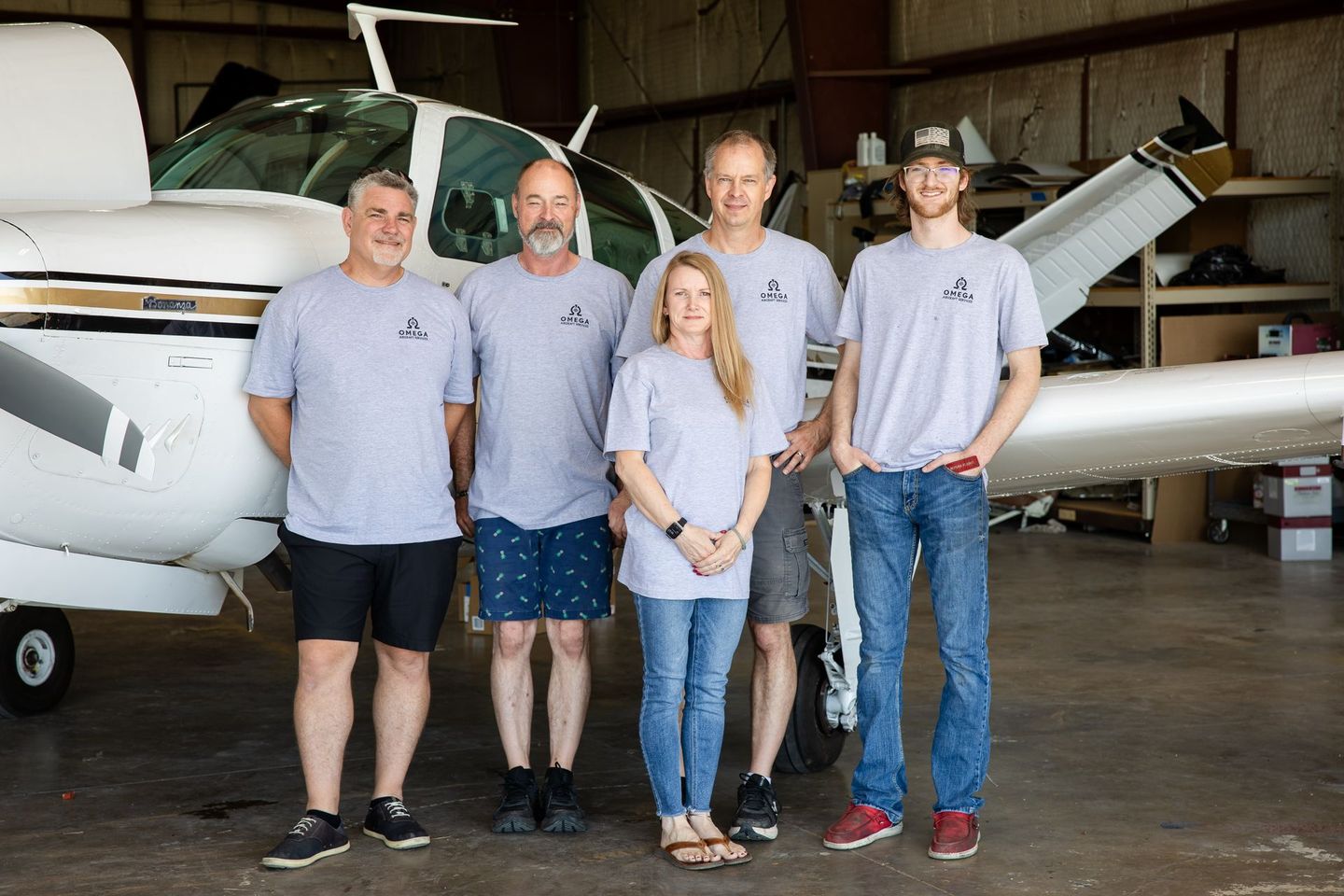Omega team standing in front of hangar