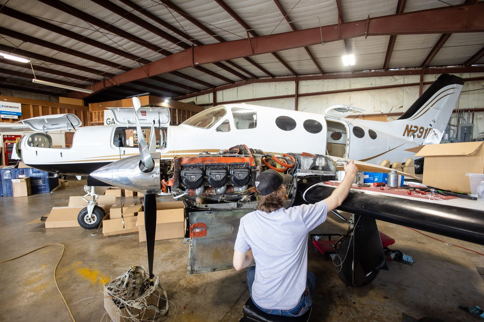Technician working on an exposed aircraft engine
