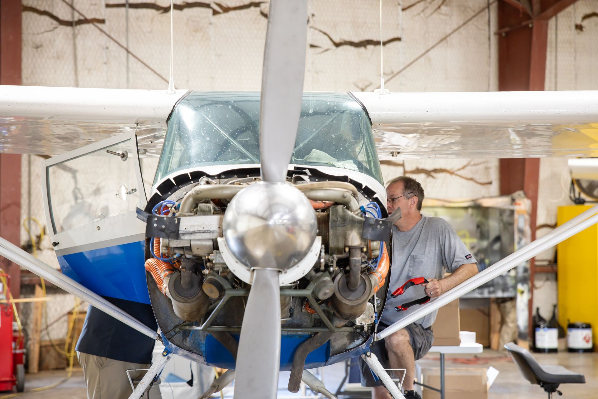Technician working on piston aircraft engine