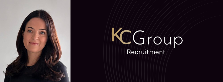 Man standing beside KC Group Recruitment logo on a dark green background