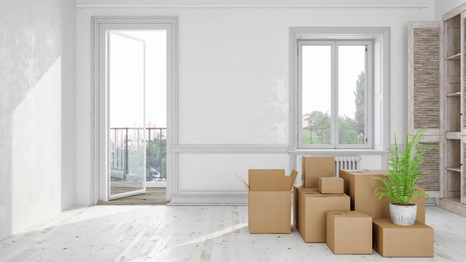 Moving boxes and packed household items in a sunlit room during a move
