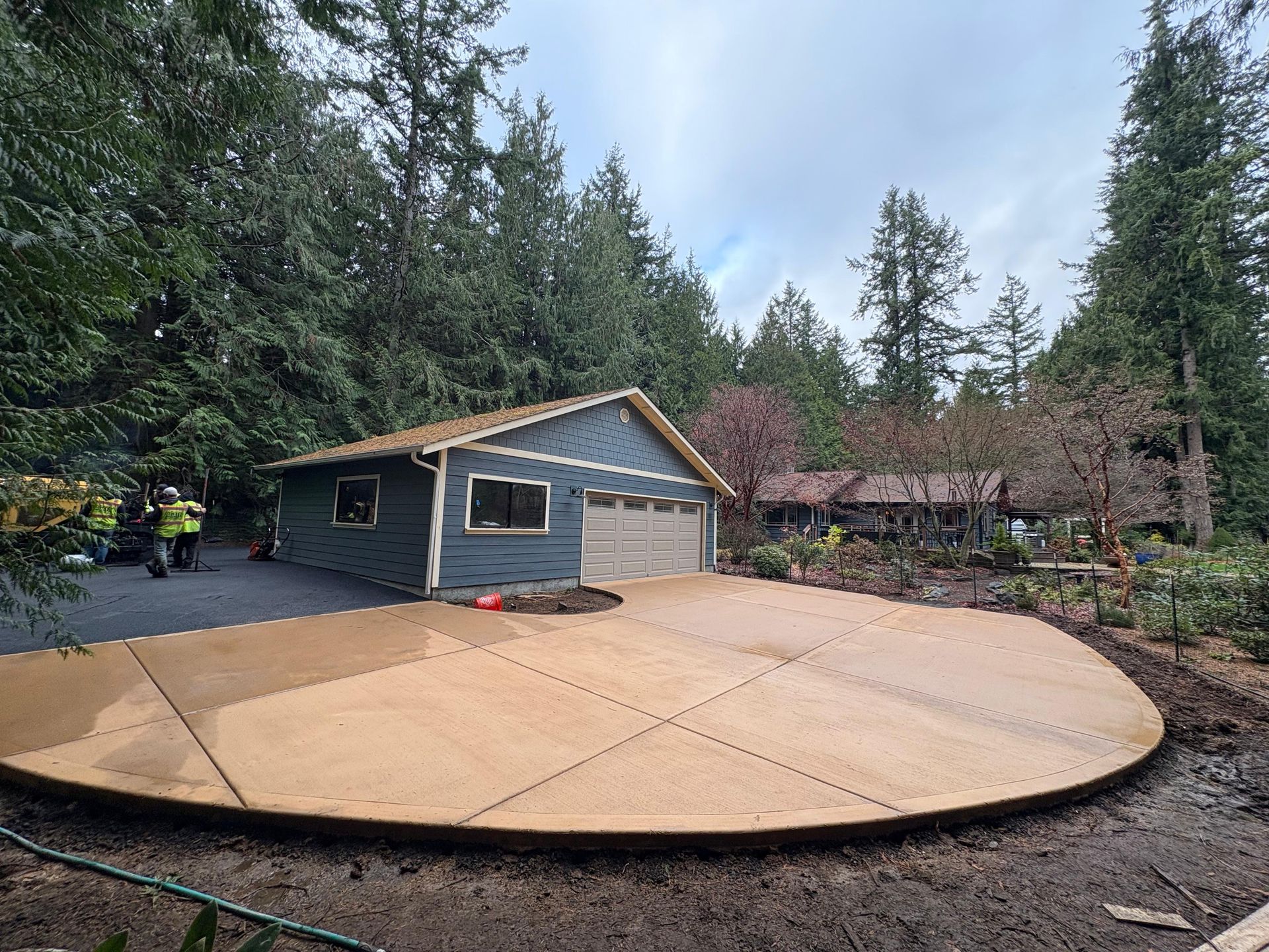 A concrete walkway is being built in a yard.