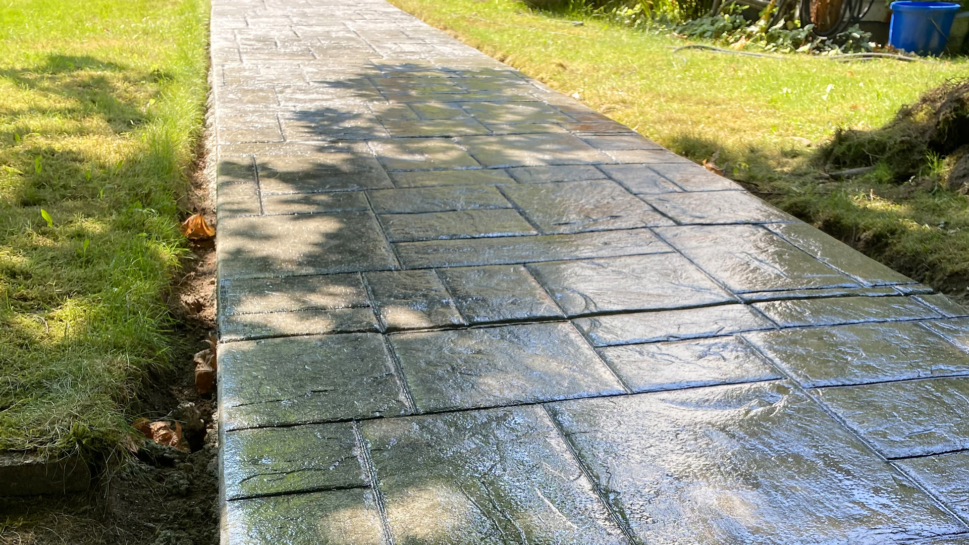 Freshly poured concrete sidewalk at a Silverdale WA home during dry summer weather