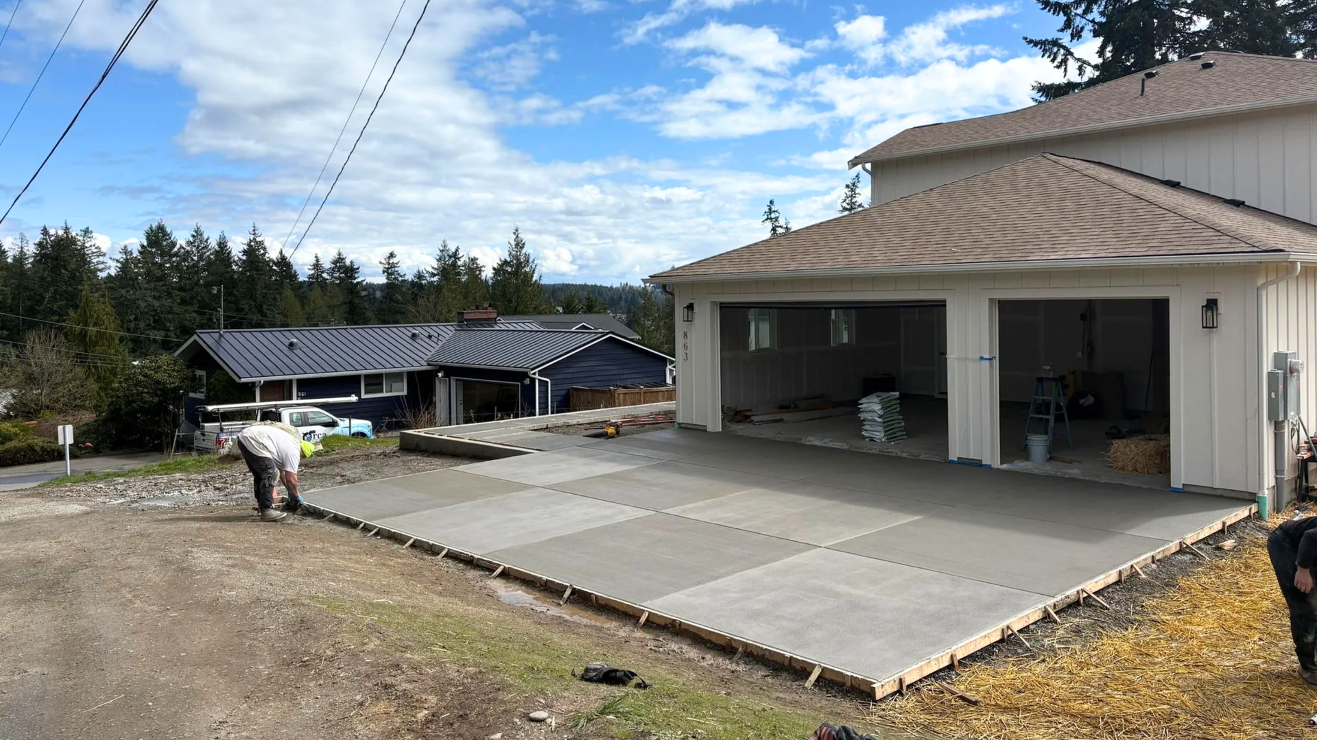 Freshly poured concrete slab foundation for a garage at a Silverdale WA property