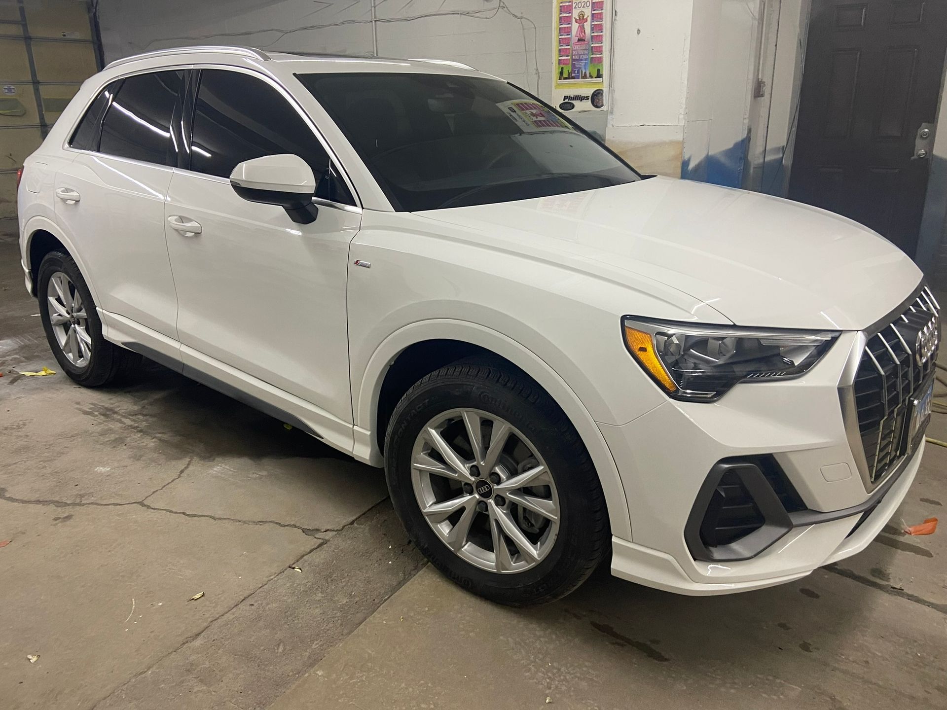 A White Audi Q3 Is Parked in A Garage — Chicago, IL — Ecuamex Autobody Inc.