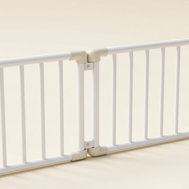 White baby safety gate attached across a doorway