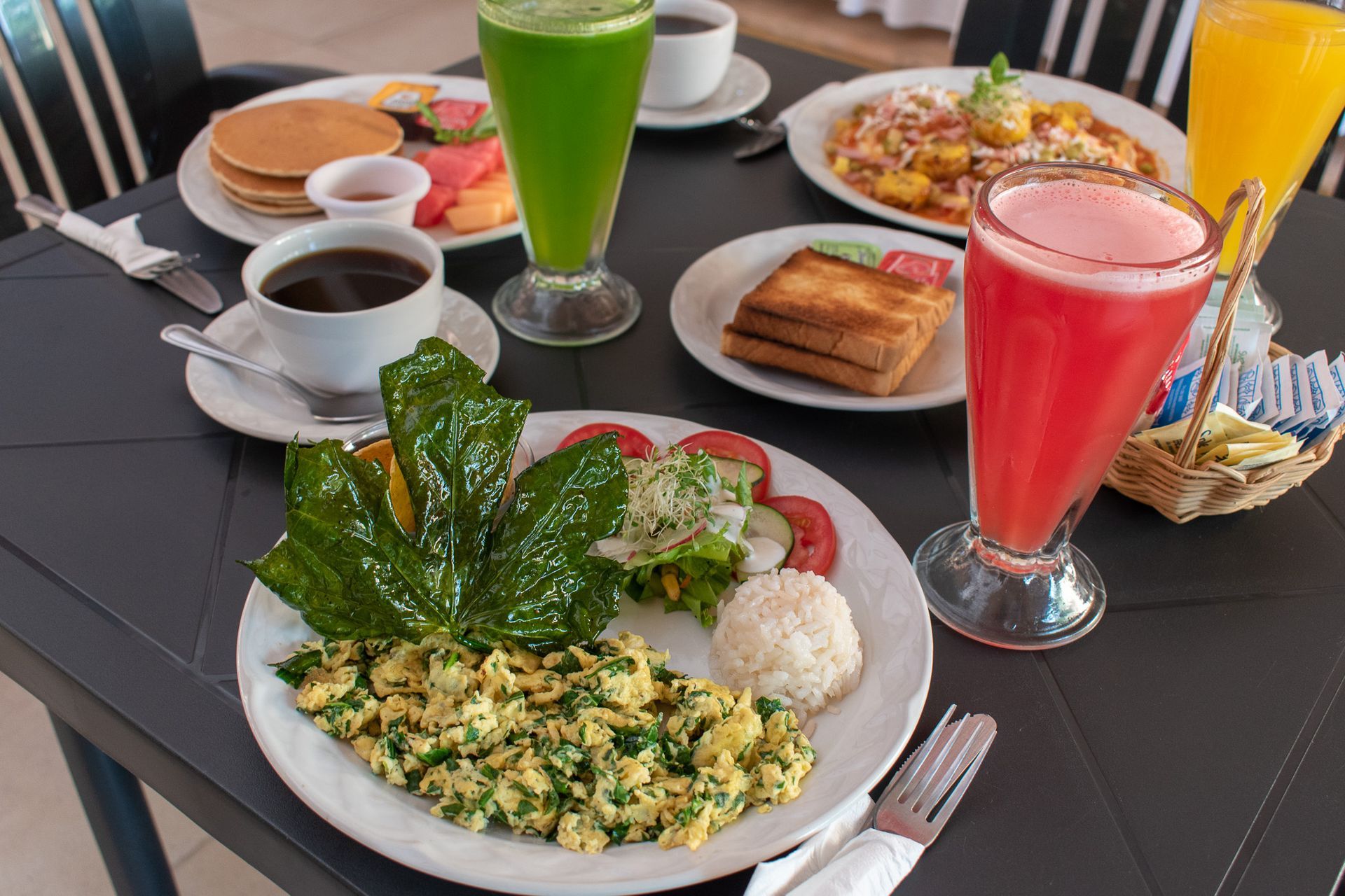 Una mesa cubierta con platos de comida y bebidas.