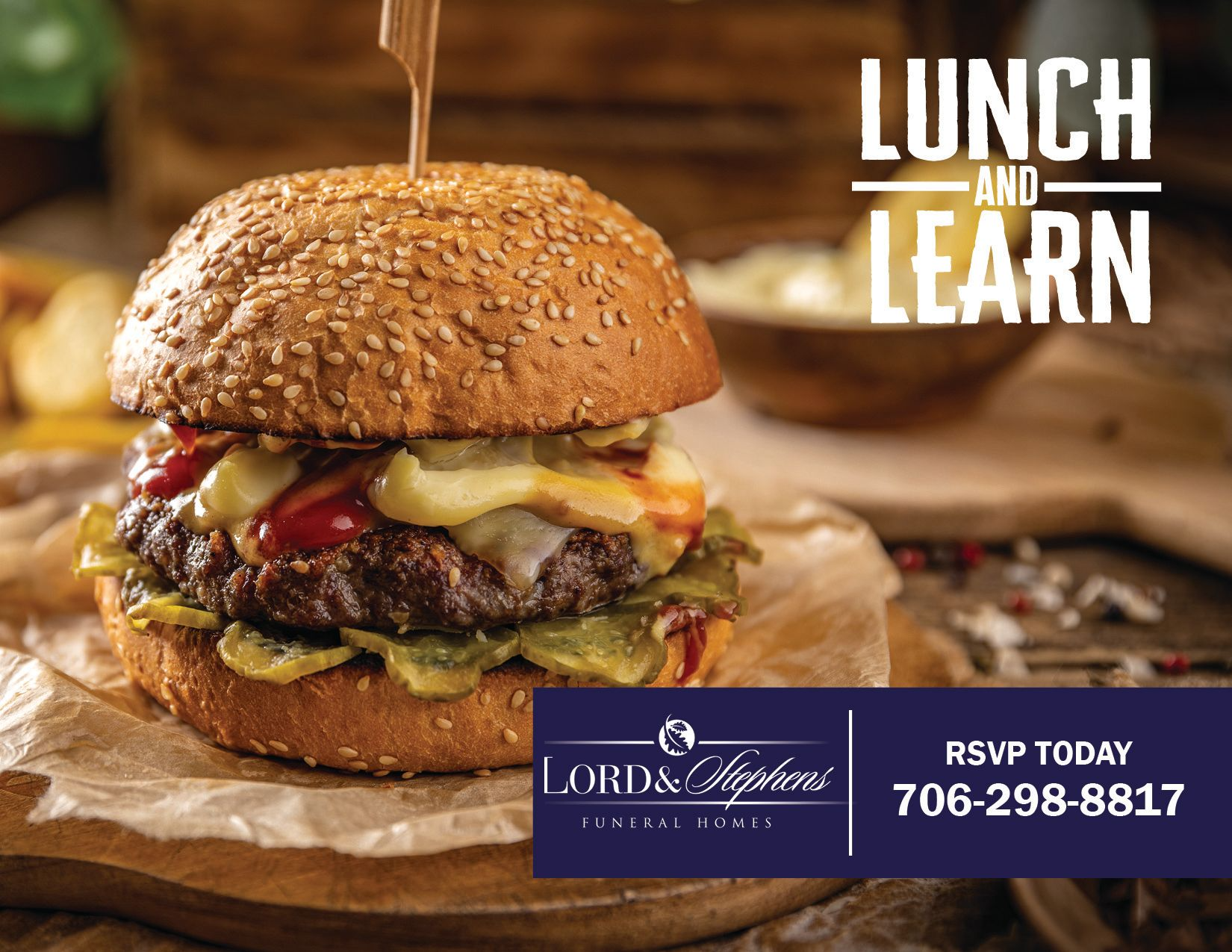 A hamburger with a toothpick in it is on a wooden table.