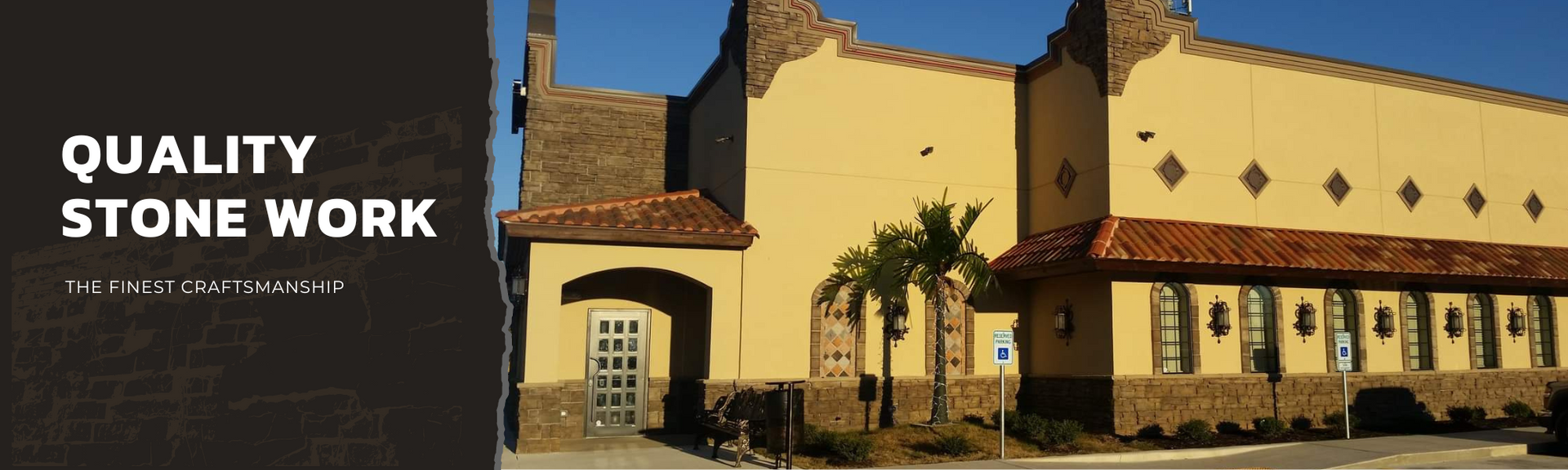 Exterior of a yellow building with stone masonry detailing, a tiled roof, and text reading
