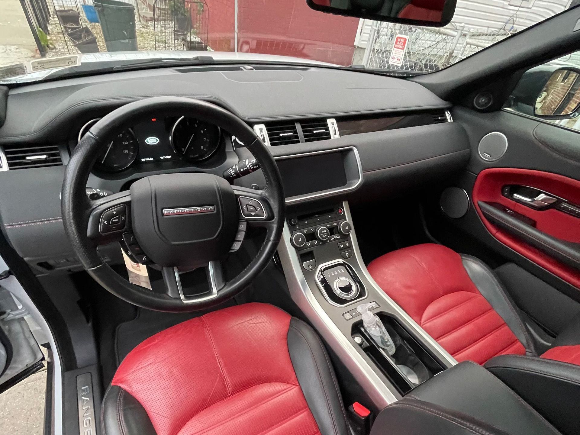 The interior of a range rover evoque with red seats