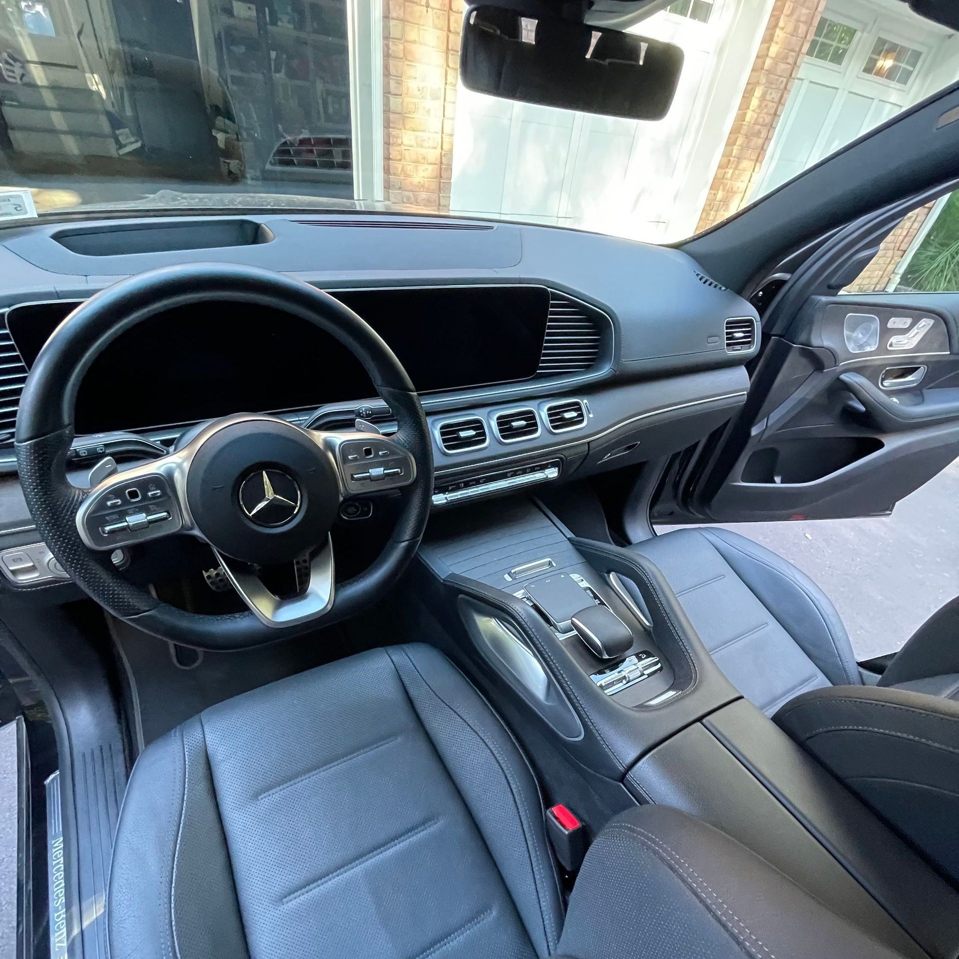 The interior of a mercedes benz gle is shown with the door open.