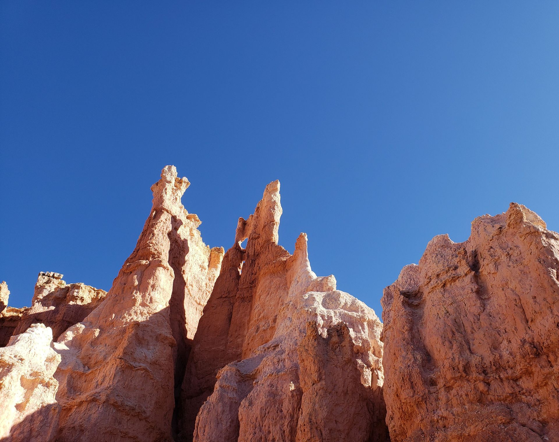 Jagged red rock formations under a clear blue sky.