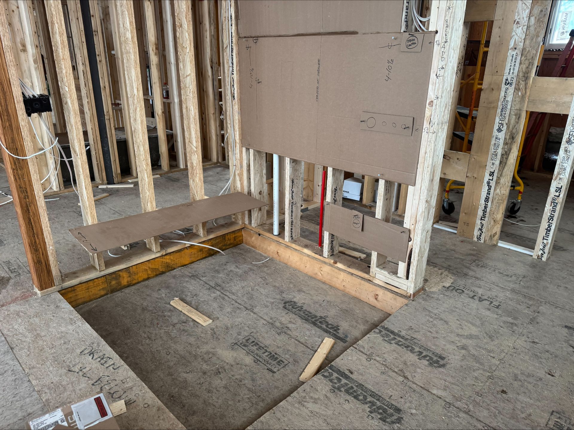 Framed interior floor opening in a construction site with unfinished walls and wooden supports