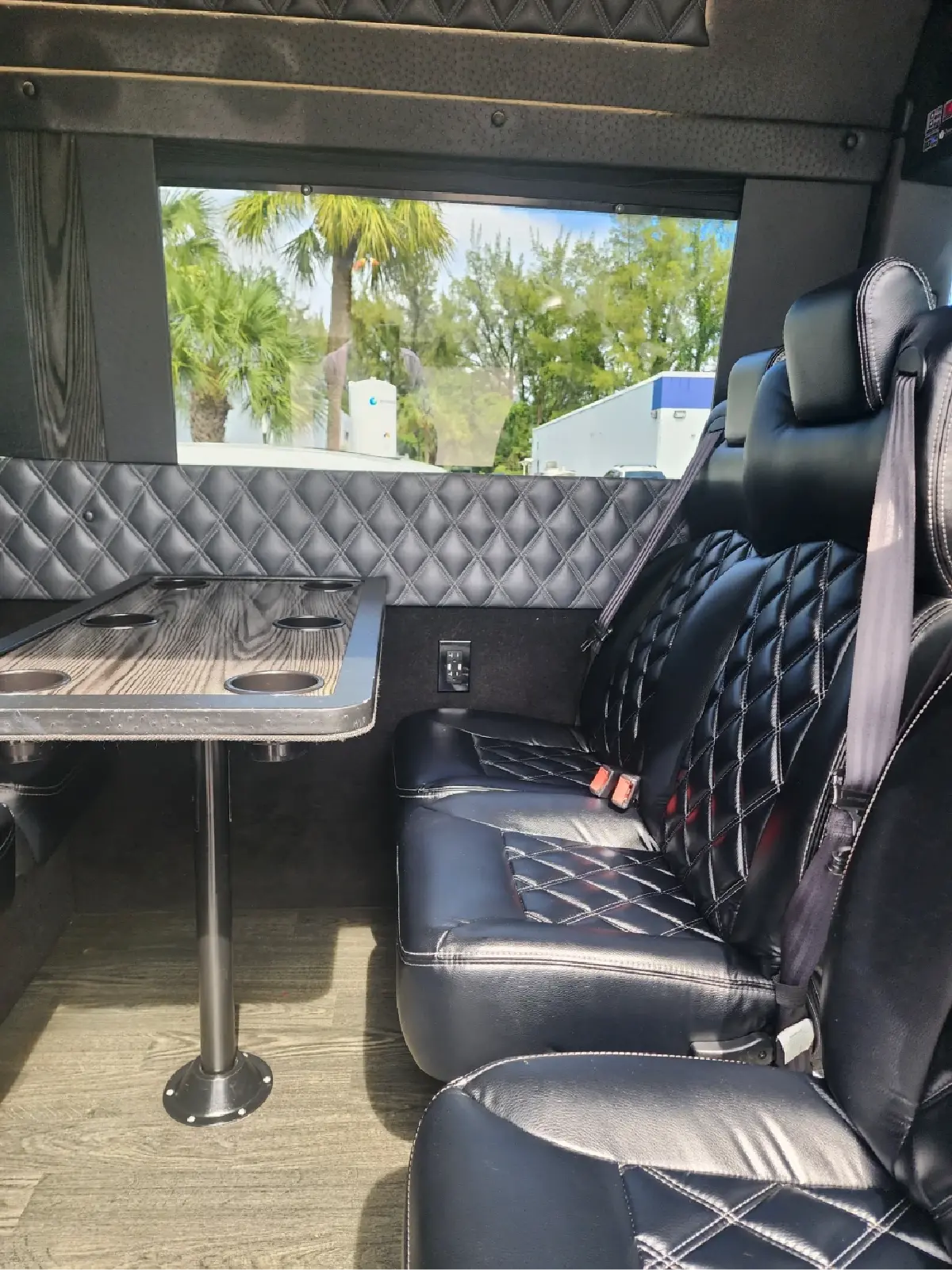 The inside of a van with a table and chairs.