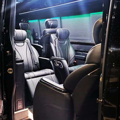 The inside of a black van with a lot of seats