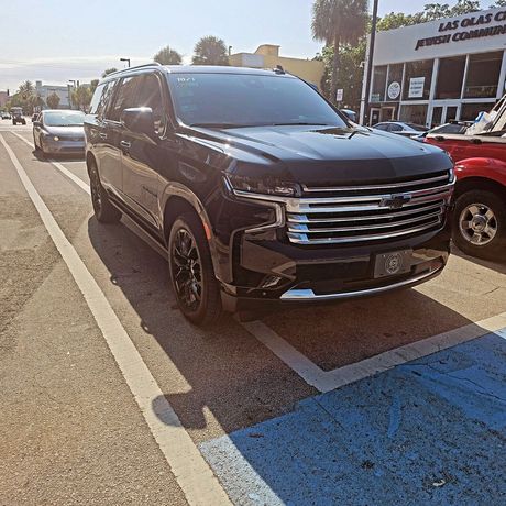 A black suv is parked on the side of the road