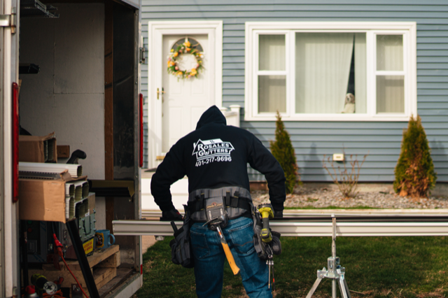 rosales gutters worker working on a gutter on a house