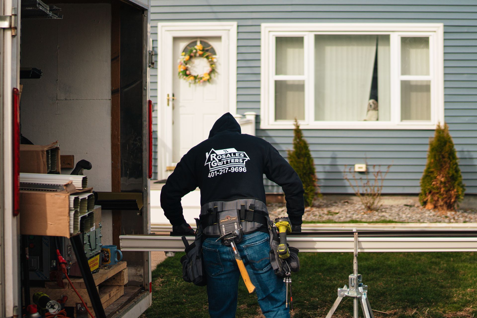 A man is standing in front of a house.