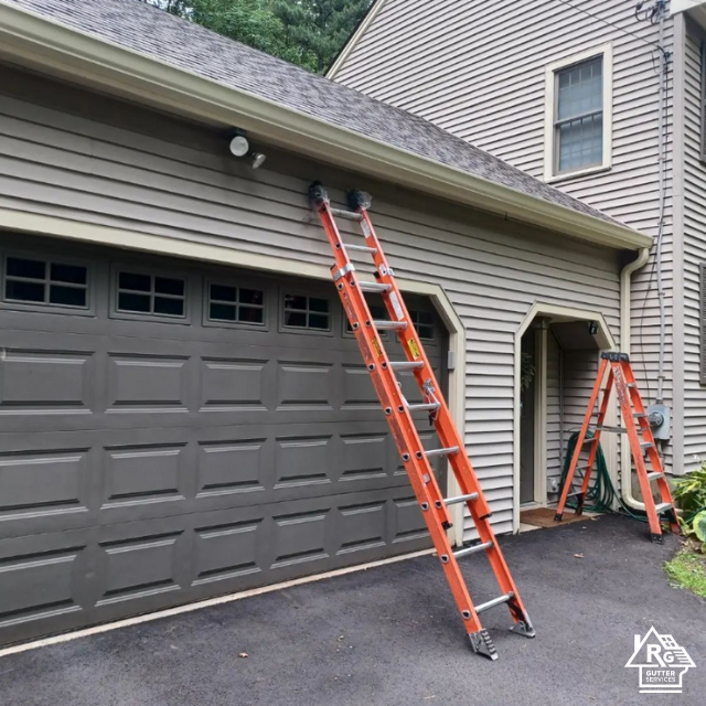 A ladder is leaning against the side of a garage door