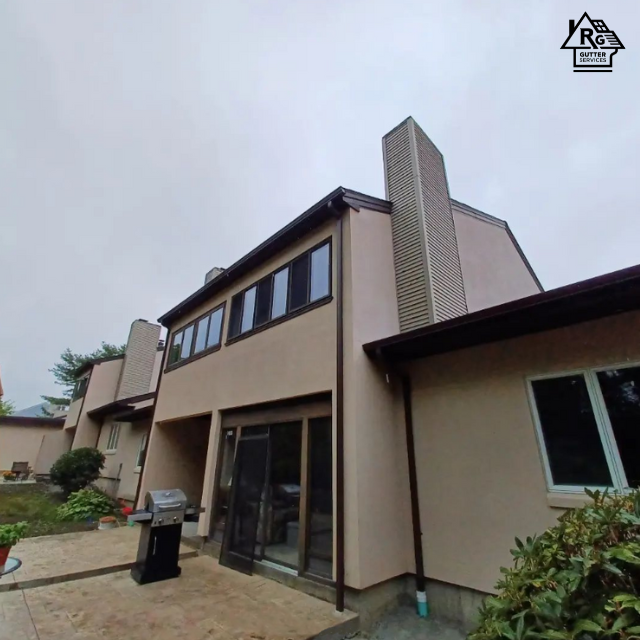 A large house with a chimney on the top of it