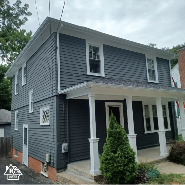 A gray house with white trim and a porch