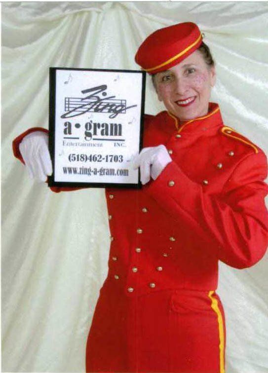 Woman in red uniform holding a sign for a cleaning company against a white backdrop