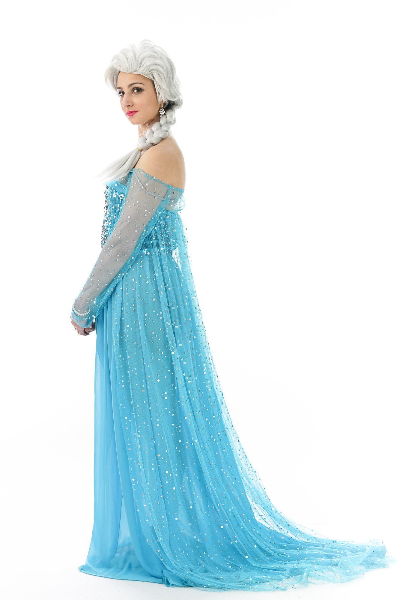 Person in a sparkling light-blue gown with a long train and silver accents, posed in profile on a white background