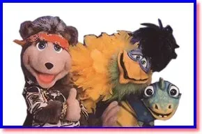 Three colorful puppets posing together, smiling against a plain white background.