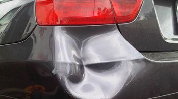 The back of a car with a skull painted on it.