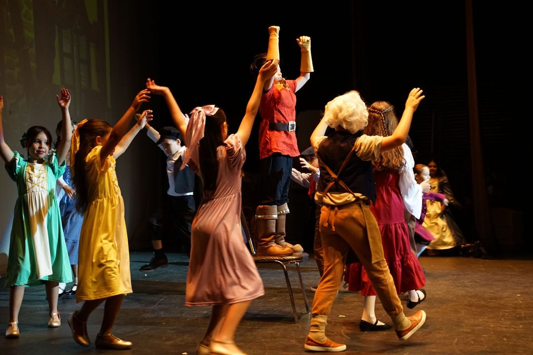 Students performing on stage in school arts event