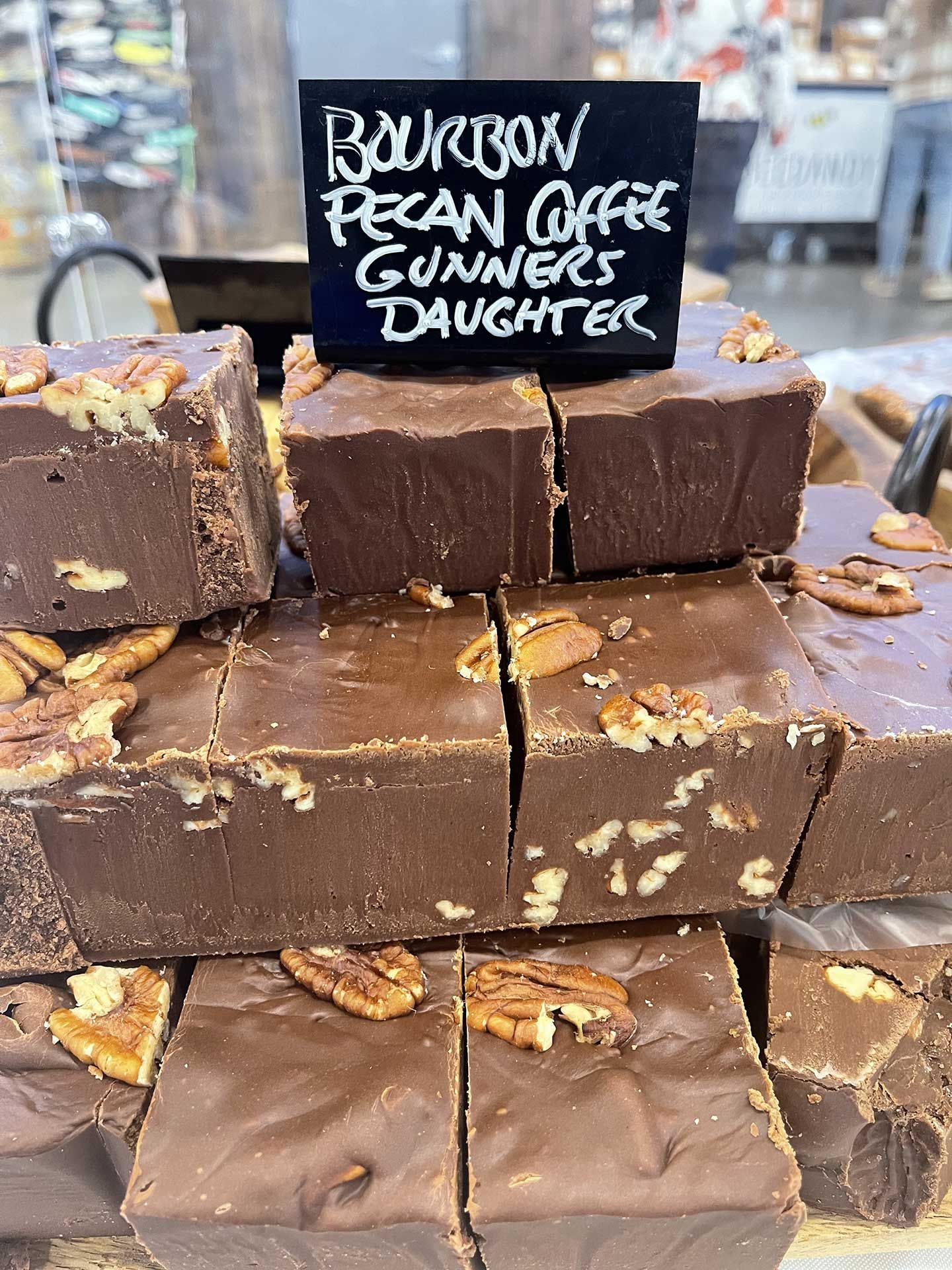Fudge squares with pecans on a shelf, labeled