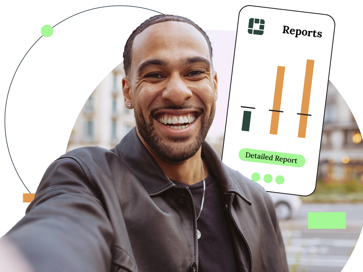 Smiling man taking a selfie, phone showing financial reports in front of an urban background.