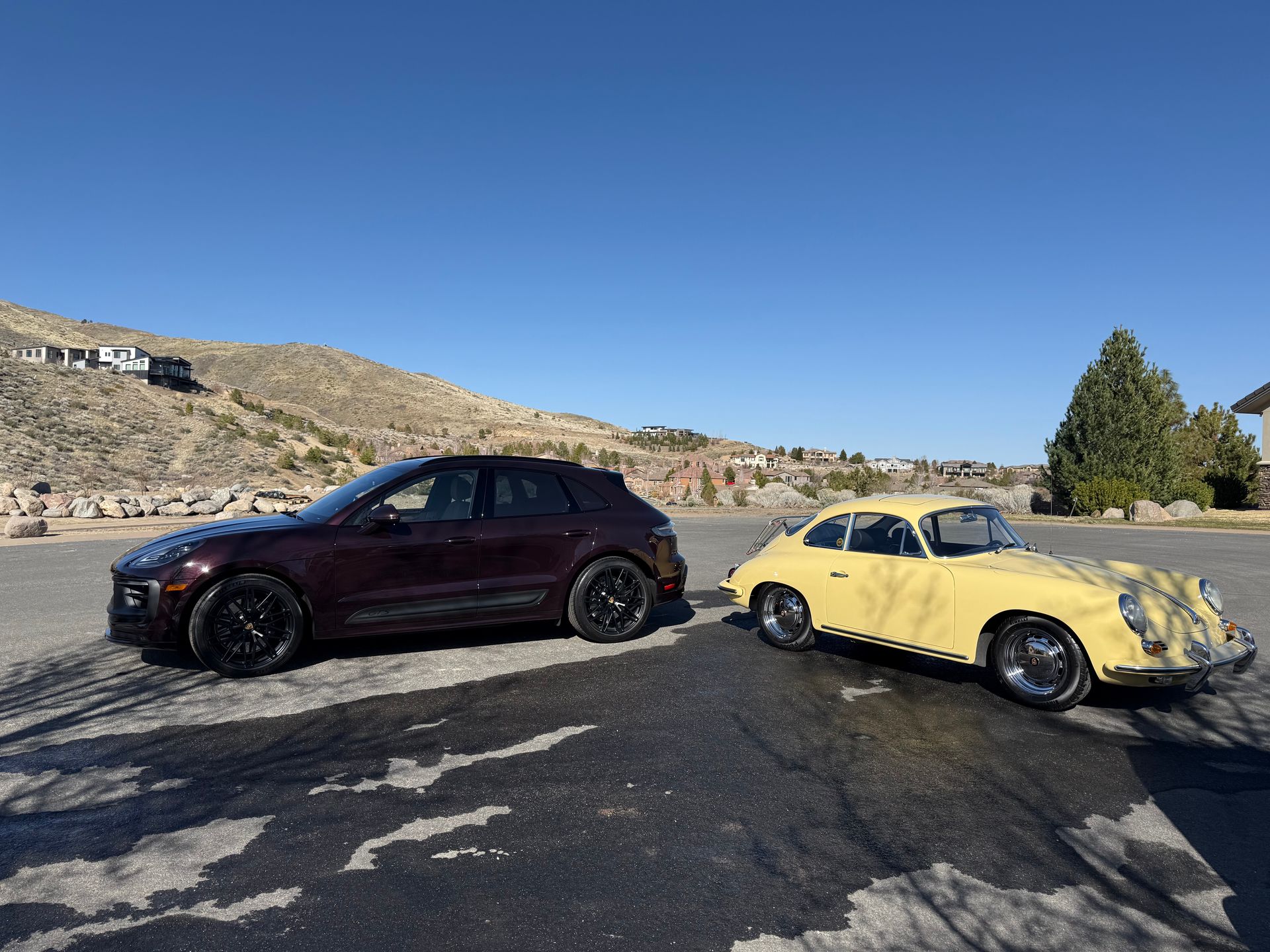 Two cars are parked next to each other in a parking lot.