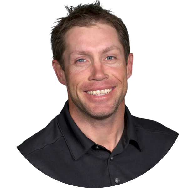Smiling man in black shirt, headshot.
