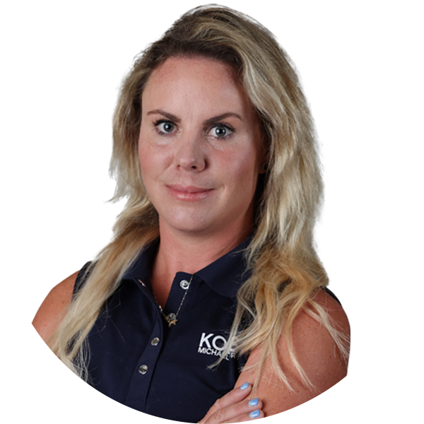 Blonde woman with arms crossed, wearing a navy shirt, with the logo 