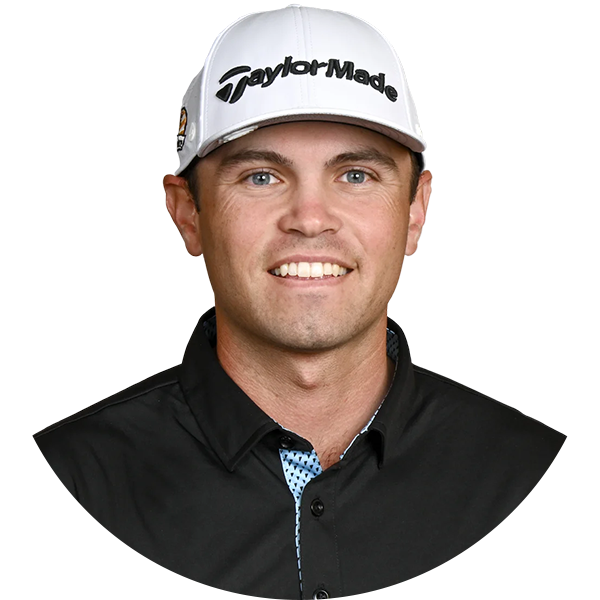 A smiling male golfer wearing a white TaylorMade cap, black shirt with patterned collar.