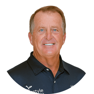 Smiling man, blue eyes, wearing a dark polo shirt.