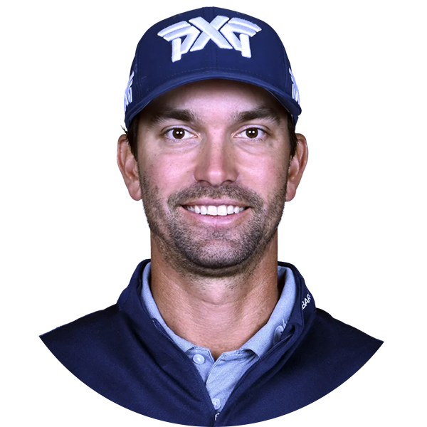 Golfer wearing a navy blue PXT hat, smiling, in front of a white background.