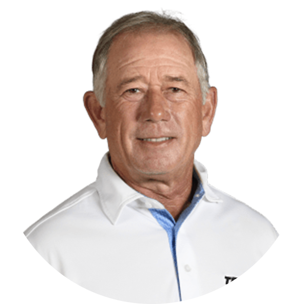 Smiling older man with short hair, wearing a white polo shirt.