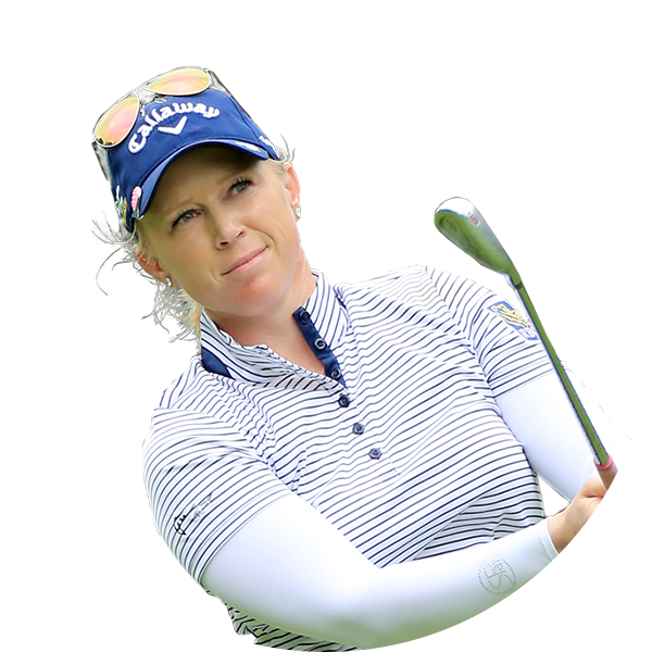 Golfer with blonde hair in a blue cap and striped shirt holding a golf club, smiling.