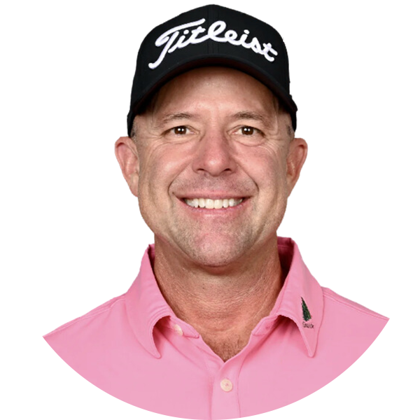 Man wearing a Titleist hat and pink shirt, smiling, headshot.