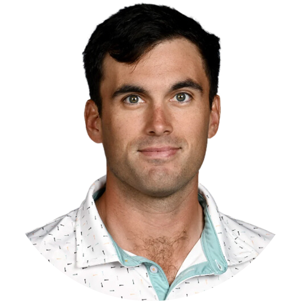 Portrait of golfer Sam Burns, smiling, wearing a white and blue collared shirt.