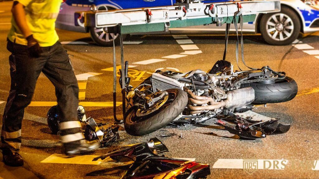 A picture of a motorcycle damaged on the ground after an accident