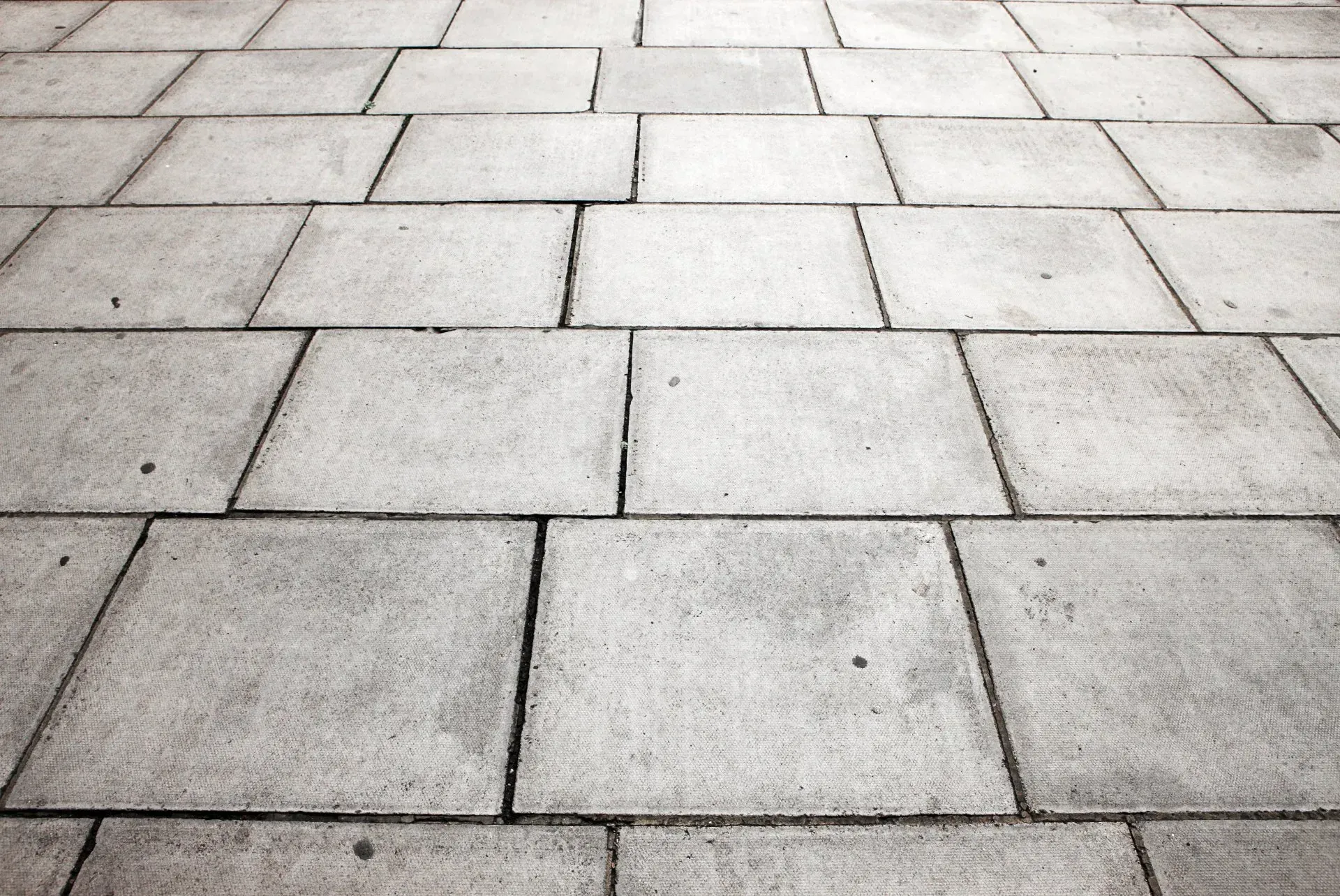 Stone walkway with rectangular gray pavers and light grout lines